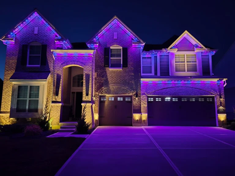 Home front lit in blue and purple with permanent roofline lights