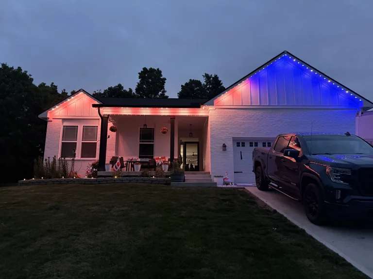 Home lit in red, white and blue with permanent roofline lights