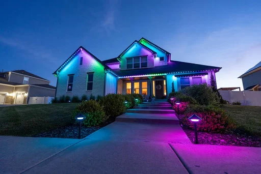 Home with JellyFish roofline lighting and landscape lighting at night